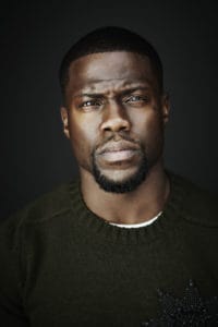 Kevin Hart stares at the camera with a serious expression on his face