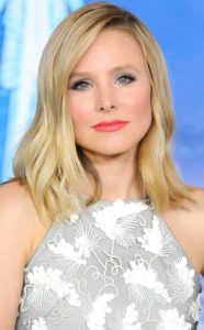 Kristen Bell smiles faintly as she looks to the camera