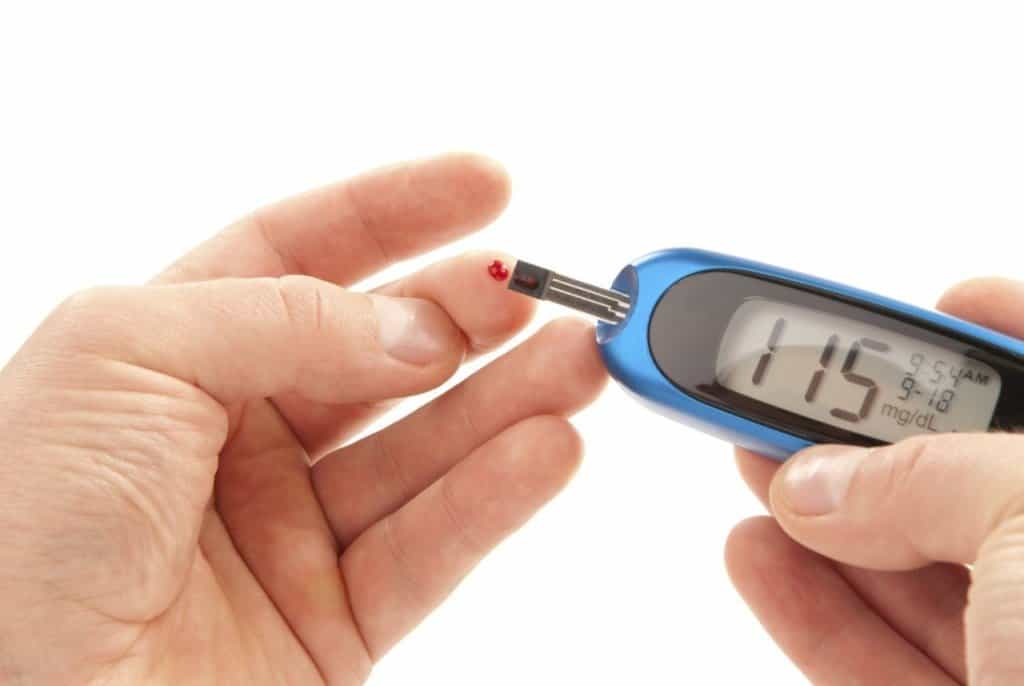 A man uses a glucometer to measure his blood sugar levels